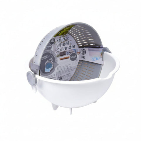A small Spin Wheel Colander in white plastic, shown with its gray inner draining basket and printed product label attached.