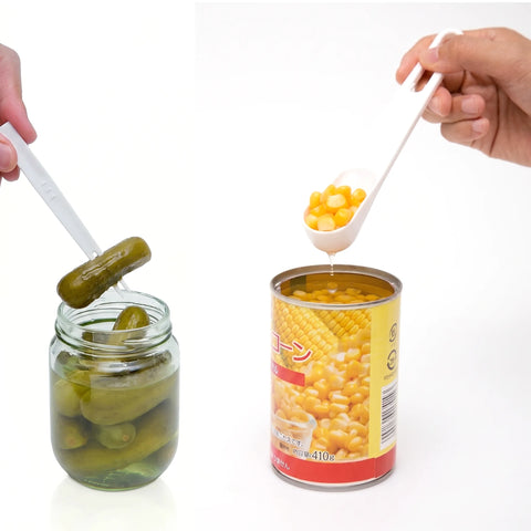 Two hands demonstrate a plastic spoon scoop against a white background, with one hand scooping yellow corn from a can and the other holding a pickle from a glass jar with the spoon.