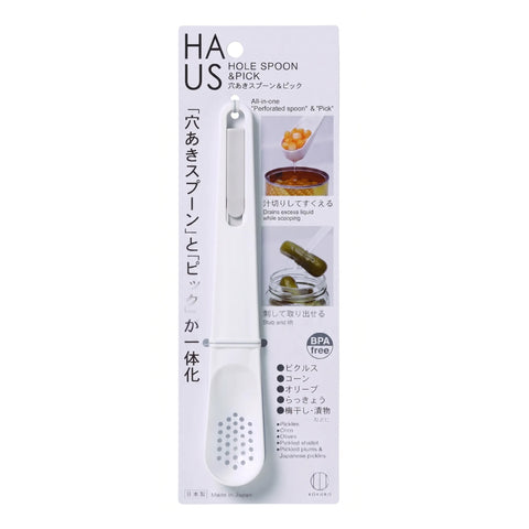 HAUS Hole Spoon & Pick kitchen utensil in its original white and silver blister packaging, featuring a white plastic spoon with a silver metal handle.