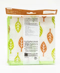 A packaged kitchen towel with a white background and a pattern of green and orange leaves, sealed in a clear plastic bag with a brown header card.