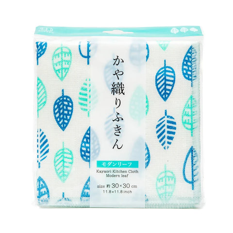 A packaged kitchen cloth set shown on a plain white background. The product is a set of white kitchen towels with a repeating leaf pattern in shades of blue and teal, sealed in clear plastic packaging with a turquoise header card and Japanese text.