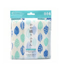 A packaged kitchen cloth with a white background and a repeating leaf pattern in blue, teal, and light green. The package has a teal header card with a hanging tab and Japanese text on the front.