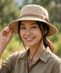 Woman wearing a beige hat and matching outfit outdoors