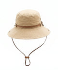 Beige bucket hat with brown leather strap on a white background