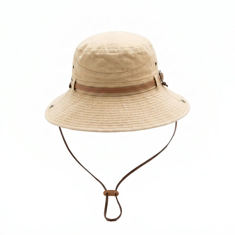 Beige bucket hat with brown leather strap on a white background