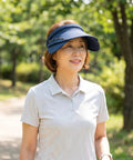 Woman wearing a blue visor outdoors