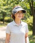 Woman wearing a white visor outdoors