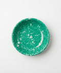 A round melamine bowl with a vibrant green and white speckled pattern, photographed from directly above on a clean white background.