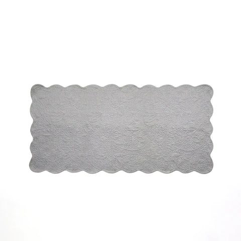 Rectangular gray rug with scalloped edge on a white background