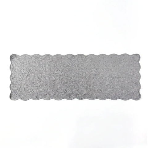 Rectangular silver doily with scalloped edge on a white background