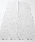 White textured rug on a white background