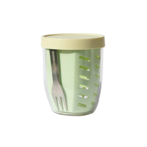 Green container with a beige lid and a fork inside on a white background