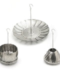 Set of three metal steamer baskets with hanging chains on a white background