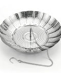 Metallic steamer basket with perforations on a white background