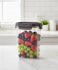 Clear container with fruits on a kitchen counter