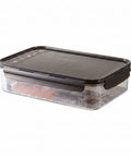 Clear food storage container with black lid on a white background