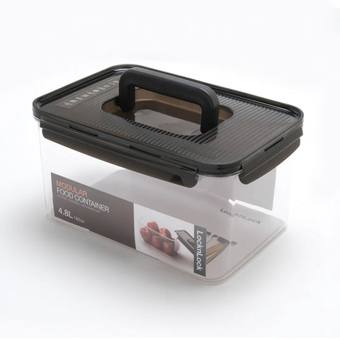 Modular food container with black lid and handle on a white background