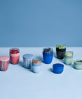 Collection of colorful containers on a light blue background
