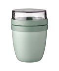 Green insulated tumbler with a clear lid on a white background