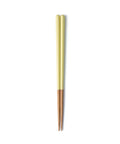 Pair of green and wooden chopsticks on a white background