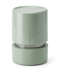 Green cylindrical food moisture remover on a white background