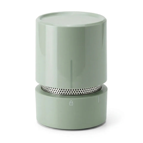 Green cylindrical food moisture remover on a white background