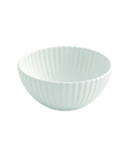 A small white ceramic bowl with a fluted, ribbed exterior and a smooth, scalloped rim, shown against a plain white background.