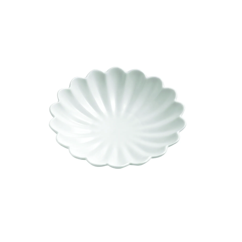 A white ceramic scalloped plate with a delicate petal or shell-like edge, shown from a top-down view on a solid white background.