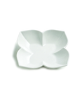 A white ceramic four-petal flower-shaped bowl or dish, photographed from directly above on a clean white background.