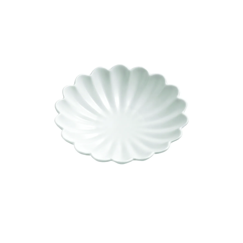 A small white ceramic plate with a scalloped, petal-like rim and a subtle radial ribbed pattern, shown on a solid white background.