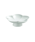 A white ceramic flower-shaped dish with a pedestal base, photographed against a seamless white background.