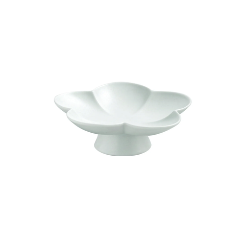 A white ceramic flower-shaped dish with a pedestal base, photographed against a seamless white background.