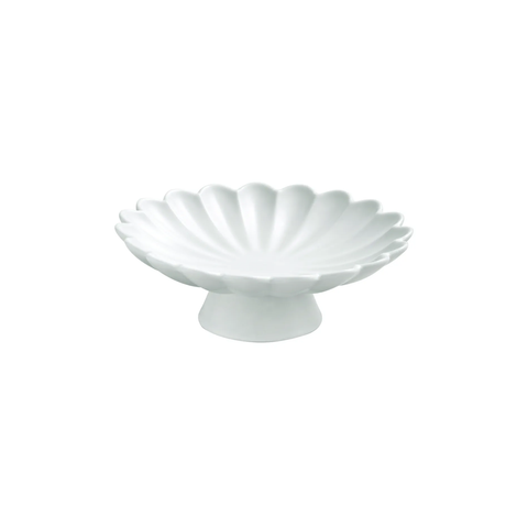 A white ceramic pedestal dish with a scalloped, shell-like rim, shown against a plain white background.