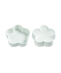 Two small flower-shaped ceramic dishes or containers shown on a plain white background, one open and one closed.