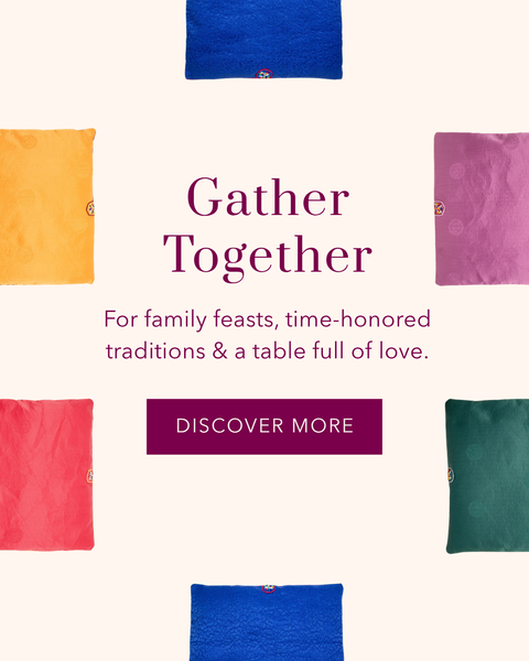 A heading image with colorful square floor cushions around a heading that says 'Gather Together - For family feasts, time-honored traditions & a table full of love. Discover More'