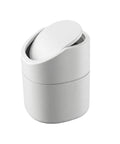 White mini trash can with a lid on a white background