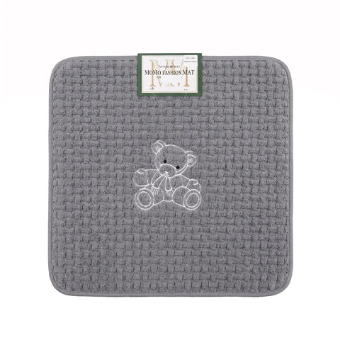 Gray textured bath mat with a teddy bear design and a visible brand label on a white background.