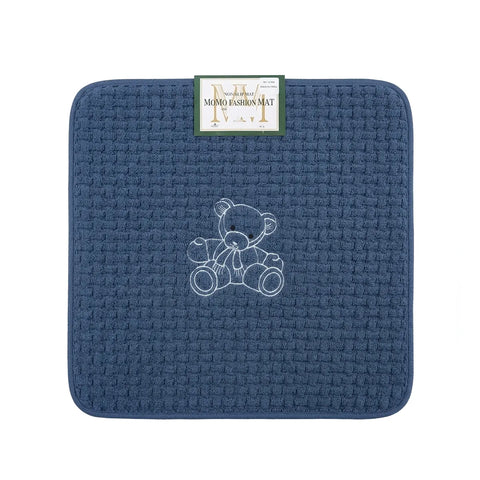 Blue textured mat with a teddy bear design and a brand label on a white background