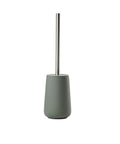 Green toilet brush with a metal handle on a white background