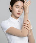 Woman wearing a beige arm sleeve against a gray background