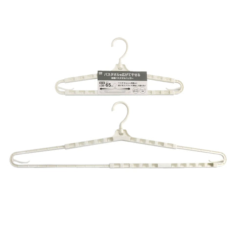 Two white plastic clothes hangers shown on a plain white background, with the top hanger still attached to its product label.