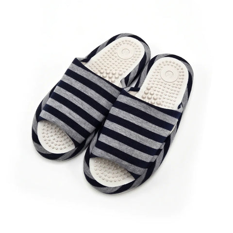 A pair of open-toe slide sandals with navy blue and gray horizontal stripes on the straps, featuring white contoured footbeds with raised massage nodules, shown on a white background.