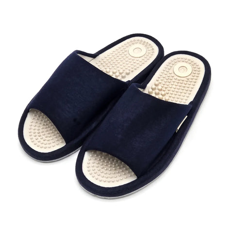 A pair of dark navy blue open-toe slippers with textured beige footbeds featuring a circular design and raised nodule details, shown on a plain white background.