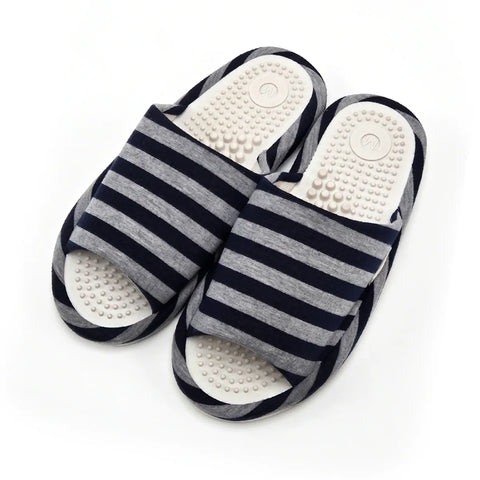 A pair of open-toe slide sandals with navy blue and gray horizontal stripes, featuring textured white footbeds with raised nodule details, shown on a plain white background.
