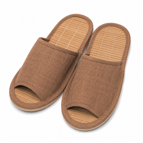 A pair of open-toe slip-on slippers with a brown woven fabric upper and a light tan bamboo-look footbed, shown on a plain white background.