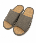 A pair of open-toe slip-on slippers with a textured gray fabric upper and a natural bamboo-look footbed, shown on a plain white background.