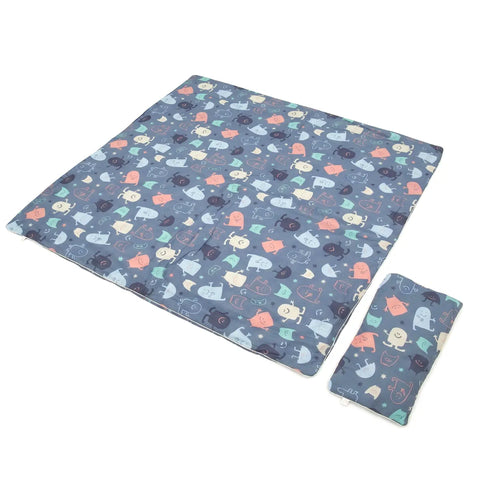 Children's foldable blanket with colorful monster pattern on a white background