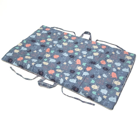 Foldable mat with cartoon monster pattern on a white background