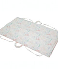 Floral-patterned mat with drawstrings on a white background