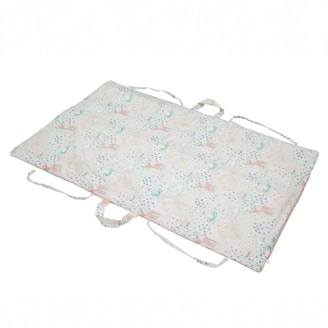 Floral-patterned mat with drawstrings on a white background